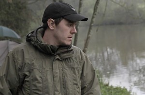 John's face standing by lake